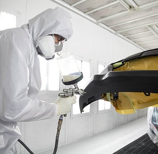 Collision Center Technician Painting a Vehicle | Zanesville Toyota in Zanesville OH
